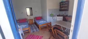 a kitchen and dining room with a table and chairs at "STELIOS & GALINI" in Symi