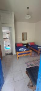 a living room with two beds and a room with at "STELIOS & GALINI" in Symi