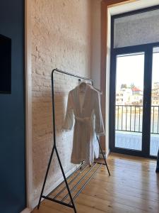 a dress on a rack in a room with a window at Apartment Riverside in Kutaisi