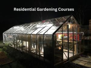 a greenhouse in the dark with the words residential gardening courses at The Bowden Lodge in Southport