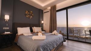 a bedroom with a bed with two towels on it at Sunrise Luxury Apartments Rhodes in Rhodes Town