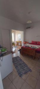een woonkamer met een bed en een bank bij "STELIOS & GALINI" in Symi