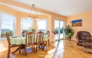 a dining room with a table and chairs at Nice Home In Kastav With 4 Bedrooms, Wifi And Outdoor Swimming Pool in Kastav