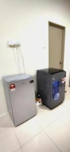 two machines sitting on the floor in a room at RaiRai Homestay Gambang in Gambang