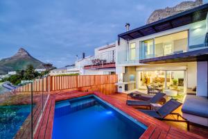 a backyard with a swimming pool and a house at Malibu in Cape Town