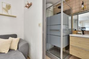 a living room with a couch and a kitchen at Superbe studio Vieux Nice 1 min à pied de la plage in Nice