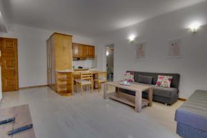 un soggiorno con divano e tavolo di The Big Cypress Apartments ad Apólpaina