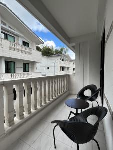 two chairs and a table on a balcony at Lucid Dream清醒夢民宿 in Yilan City