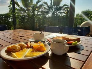 a table with a plate of food and a cup of coffee at Kerkyra Beach Hotel & Apartments in Benitses