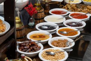 a buffet with many bowls of different types of food at Almaty Hotel in Almaty