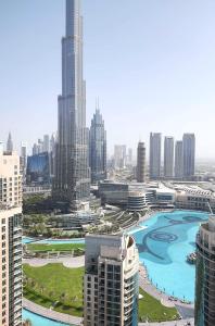 a view of a city with tall buildings and a river at Silkhaus full Burj Khalifa & Fountains view in Downtown in Dubai