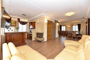 a living room with a couch and a kitchen at Spa Villa Trakai in Trakai