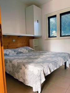 a bedroom with a bed in a room at Lianna Beach Resort in Marina di Montenero