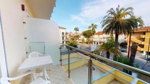 a balcony with a white chair and a view of a street at Miriam Hotel & Residence in Pietra Ligure