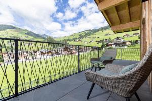 a balcony with chairs and a view of a valley at Franzerl in Tux