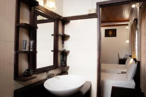 a bathroom with a white sink and a window at Villa Senesouk Luang Prabang in Luang Prabang