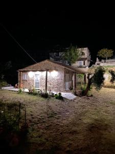 a stone house at night with lights on it at Anna Studios in Marathias
