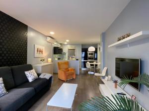 a living room with a couch and a table at Gros City Apartments in San Sebastián