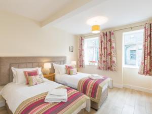 A bed or beds in a room at Rose Cottage with Hot Tub