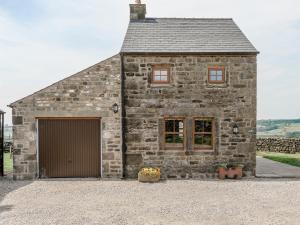 an old stone barn with a garage at The Old Hat Factory in Scotforth