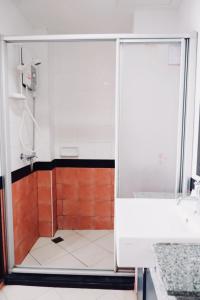 a shower with a glass door in a bathroom at Ratana Residence Thalang in Thalang