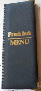 un libro con las palabras "fresco y fresco" merrill en Habermotel Enterprise Ltd en Entebbe
