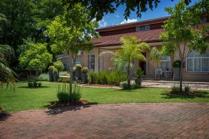 a brick driveway in front of a house at Park Living Guesthouse in Bloemfontein