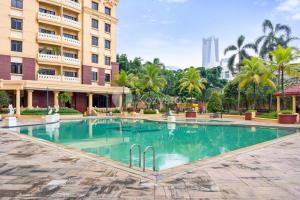 a swimming pool in front of a building at VEGA by Kozystay 3BR SCBD in Jakarta