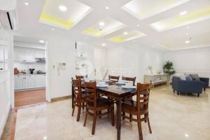 a dining room and kitchen with a table and chairs at VEGA by Kozystay 3BR SCBD in Jakarta