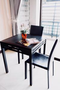 a black desk with a chair and a laptop on it at Ratana Residence Thalang in Thalang