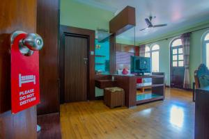 a living room with a kitchen with a tv and a room with at Hotel Snowland in Pokhara