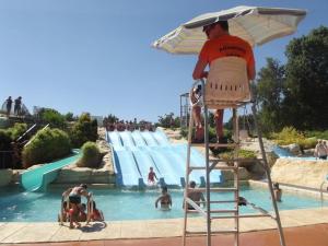 a man standing on a lifeguard stand in front of a water park at Le 104 Feuvrier in Dole
