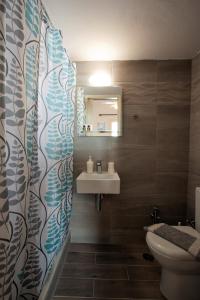 a bathroom with a sink and a toilet at Marisa Rooms in Parikia