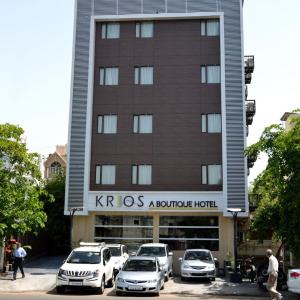 a row of cars parked in front of a hotel at Krios Hotel in Ahmedabad