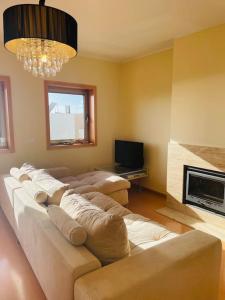 a living room with a couch and a fireplace at Apartamento foz village in Buarcos