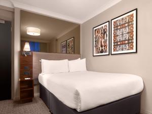Ein Bett oder Betten in einem Zimmer der Unterkunft Strand Palace Hotel