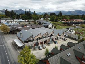 an aerial view of a town with cars parked in a parking lot at Central Apartment in Hanmer Springs