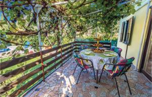 a table and chairs on a patio with a fence at 3 Bedroom Stunning Home In Kastav in Kastav