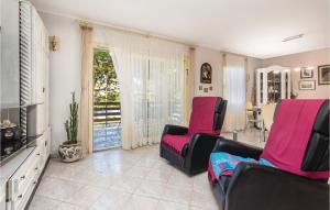 a living room with two chairs and a television at 3 Bedroom Stunning Home In Kastav in Kastav