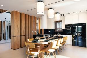 a dining room with a long table and chairs at Macaw Luxury Residence, daily housekeeping included! in Skaleta