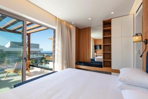 a bedroom with a bed and a balcony at Macaw Luxury Residence, daily housekeeping included! in Skaleta +81 photos