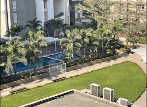 an overhead view of a park with a pool and palm trees at Royal Humming Bird in Pune