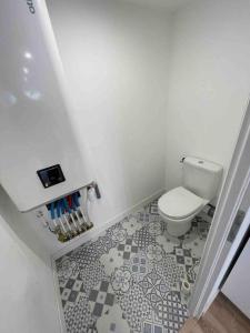 La salle de bains est pourvue de toilettes et de carrelage. dans l'établissement Appartement neuf tout confort à Blaye proche de la Citadelle, à Blaye