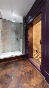 a bathroom with a shower and a glass door at Linton Collection - 28 North Bridge in Edinburgh