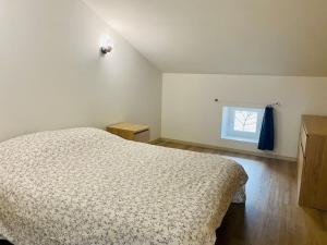 a bedroom with a bed and a window at Appartement neuf avec Spa in Saint-Martin-dʼArdèche