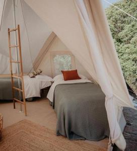 a bedroom with two beds in a tent at Il Mulino dei Veraghi The Mill at the Falls in Molina