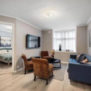 a living room with a couch and chairs and a bed at Holmboe Apartment in Bergen