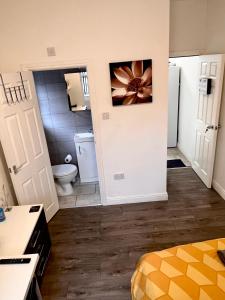 a small bathroom with a toilet and a sink at Deluxe En-suite room in CV1 in Coventry
