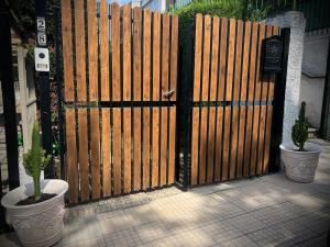 a wooden gate with two cactuses in front of it at Al civico 28 in Santa Marinella