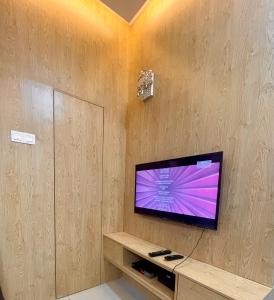 a flat screen tv on a wall in a room at Sofiamuslim Homestay Putrajaya in Putrajaya